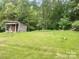 Rustic outbuilding on expansive land, offering potential for storage or a unique workspace at 7412 Broken Oak Ln, Charlotte, NC 28226