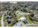 Aerial view of the property and neighborhood, showing the proximity to community amenities like tennis courts and a pool at 880 Craigmont Nw Ln, Concord, NC 28027