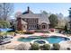 Expansive backyard with pool, patio, and outdoor kitchen provides luxury outdoor living space at 880 Craigmont Nw Ln, Concord, NC 28027