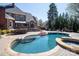 Stunning backyard oasis with a pool, spa, and lounge area enhances outdoor living at 880 Craigmont Nw Ln, Concord, NC 28027