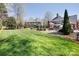 Beautifully landscaped backyard showcasing a well-manicured lawn, stone accents, and inviting outdoor seating areas at 880 Craigmont Nw Ln, Concord, NC 28027