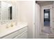 Bathroom with a white vanity, gold faucet and a view into a bedroom at 880 Craigmont Nw Ln, Concord, NC 28027