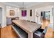Charming dining room featuring a rustic table, modern chandelier, and a convenient wine bar at 880 Craigmont Nw Ln, Concord, NC 28027