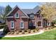 Stunning brick home boasts meticulous landscaping and architectural details like arched windows at 880 Craigmont Nw Ln, Concord, NC 28027