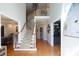 Grand foyer features hardwood floors, soaring ceilings, and a staircase with white wood railing at 880 Craigmont Nw Ln, Concord, NC 28027