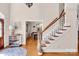 Inviting foyer showcases hardwood floors, a staircase with white railings, and views of the dining room at 880 Craigmont Nw Ln, Concord, NC 28027