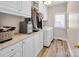 Well-lit laundry room features built-in cabinets, counter space, and modern washer and dryer at 880 Craigmont Nw Ln, Concord, NC 28027