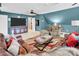 Inviting living room with blue walls, plush seating, and colorful rug creates a cozy space at 880 Craigmont Nw Ln, Concord, NC 28027
