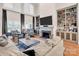 Bright living room boasts a fireplace, built-in bookshelves, hardwood floors and large windows at 880 Craigmont Nw Ln, Concord, NC 28027