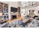 Spacious living room with a fireplace, built-in bookshelves, and a view of the upper level at 880 Craigmont Nw Ln, Concord, NC 28027