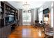 Bright office features custom built-ins, hardwood floors, large windows, and a cozy sitting area at 880 Craigmont Nw Ln, Concord, NC 28027