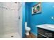 Stylish bathroom features a sleek glass-door shower and modern fixtures against vibrant blue walls at 9200 Surrey Rd, Mint Hill, NC 28227