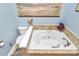 Relaxing bathroom featuring a large soaking tub, tiled surround, and elegant fixtures at 9200 Surrey Rd, Mint Hill, NC 28227