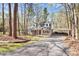 Welcoming brick home with a covered porch, manicured lawn, and a long driveway leading to the carport at 9200 Surrey Rd, Mint Hill, NC 28227