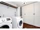 Bright laundry room features modern washer and dryer, storage cabinets, and convenient shelving at 9200 Surrey Rd, Mint Hill, NC 28227