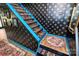 Unique staircase with decorative wallpaper, blue accents, and stylish rugs at 9200 Surrey Rd, Mint Hill, NC 28227