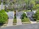 Aerial view of a home with well-maintained landscaping, driveway, and mature trees at 9209 Tibble Creek Way, Charlotte, NC 28227