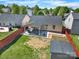 Aerial view of a backyard with a covered patio, fire pit, seating, and a privacy fence at 9209 Tibble Creek Way, Charlotte, NC 28227