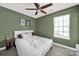 Cozy bedroom with a ceiling fan, wood-look flooring, and natural light at 9209 Tibble Creek Way, Charlotte, NC 28227