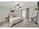 Relaxing bedroom with wood-look floors, a ceiling fan, and neutral decor at 9209 Tibble Creek Way, Charlotte, NC 28227