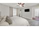 Light-filled bedroom features wood-look flooring, ceiling fan and modern decor at 9209 Tibble Creek Way, Charlotte, NC 28227