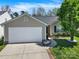 Charming single-Gathering home featuring a two-car garage, well-manicured lawn, and mature landscaping at 9209 Tibble Creek Way, Charlotte, NC 28227