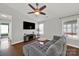 Cozy living room showcasing hardwood floors, modern lighting, and a comfortable gray sectional couch at 9209 Tibble Creek Way, Charlotte, NC 28227