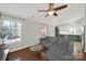 Bright living room with a large sectional couch, wood floors, and a view into the kitchen at 9209 Tibble Creek Way, Charlotte, NC 28227