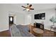 Comfortable living room featuring stylish gray sofa, modern decor, hardwood flooring and a large window at 9209 Tibble Creek Way, Charlotte, NC 28227