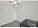 Neutral-toned room with ceiling fan, grey floors, a door, and cage at 9209 Tibble Creek Way, Charlotte, NC 28227