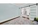 This bedroom features wood floors, soft blue walls, and sliding glass doors leading to a stairwell at 110 Sonnys Way, Fort Mill, SC 29708