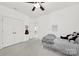 Neutral bedroom featuring a ceiling fan, plush bedding, and closet space at 110 Sonnys Way, Fort Mill, SC 29708