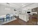 The dining area flows into the kitchen and Gathering room with wood floors and neutral paint at 110 Sonnys Way, Fort Mill, SC 29708