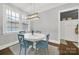 Cozy dining area featuring a modern light fixture, white table, and stylish blue chairs at 110 Sonnys Way, Fort Mill, SC 29708
