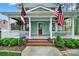 Inviting front porch with American flags, classic columns, and manicured shrubs enhancing the curb appeal at 110 Sonnys Way, Fort Mill, SC 29708