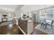 The kitchen has an open concept with stainless steel appliances, stone breakfast bar, and wood floors at 110 Sonnys Way, Fort Mill, SC 29708
