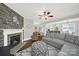 Cozy living room with stone fireplace, hardwood floors, and open layout into the kitchen and dining area at 110 Sonnys Way, Fort Mill, SC 29708