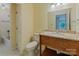 A well-lit bathroom featuring a wood vanity with granite top, toilet, and bathtub at 1101 E Morehead St # 31, Charlotte, NC 28204
