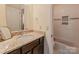 A well-lit bathroom features a granite vanity, tub with white subway tile surround at 1101 E Morehead St # 31, Charlotte, NC 28204