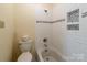 A clean bathroom featuring white subway tile, tub with shower, and a modern toilet at 1101 E Morehead St # 31, Charlotte, NC 28204