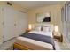 The staged bedroom has neutral walls, a wooden bed frame, and stylish decor at 1101 E Morehead St # 31, Charlotte, NC 28204