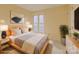 The staged bedroom has neutral walls, a wooden bed frame, and a large window at 1101 E Morehead St # 31, Charlotte, NC 28204