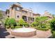 Exterior view of a well-maintained building with a courtyard, a fountain, and manicured landscaping at 1101 E Morehead St # 31, Charlotte, NC 28204