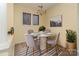 Cozy dining area featuring a round table, four chairs, modern chandelier, and bright natural light at 1101 E Morehead St # 31, Charlotte, NC 28204