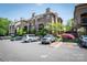 Exterior view of a condominium complex with mature landscaping and ample parking at 1101 E Morehead St # 31, Charlotte, NC 28204