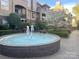 Beautiful condominium complex featuring a lovely fountain, mature trees and lush landscaping at 1101 E Morehead St # 31, Charlotte, NC 28204