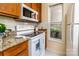 A well-lit kitchen features white appliances, granite countertops, and wood cabinets at 1101 E Morehead St # 31, Charlotte, NC 28204