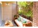 Relaxing outdoor patio with comfortable seating surrounded by lush greenery and a privacy door at 1101 E Morehead St # 31, Charlotte, NC 28204