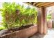 Private patio area with brick accents and lush green landscaping at 1101 E Morehead St # 31, Charlotte, NC 28204