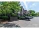 Street view of a condominium complex with available parking and tidy landscaping in front at 1101 E Morehead St # 31, Charlotte, NC 28204